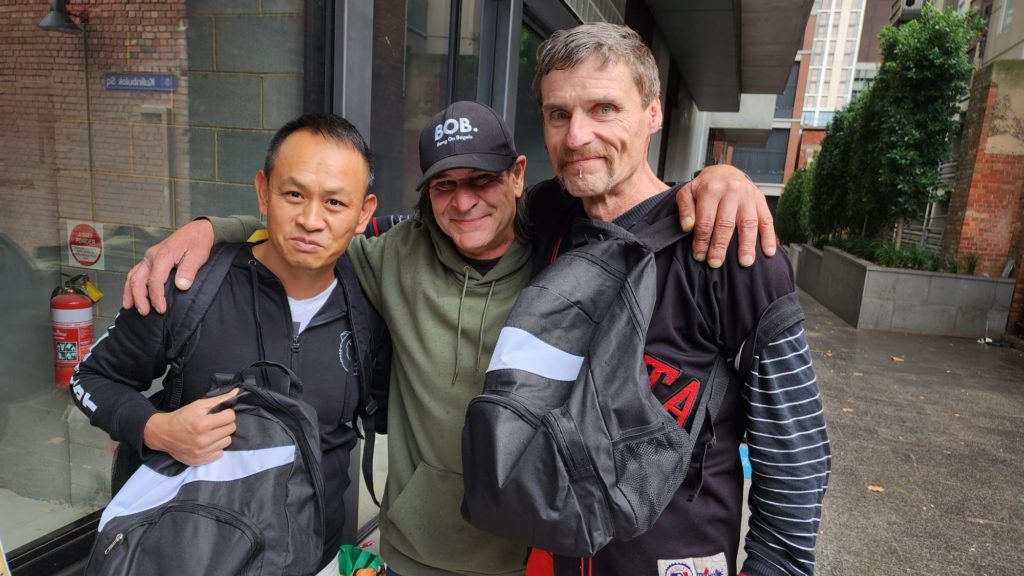 give backpack giving back team building