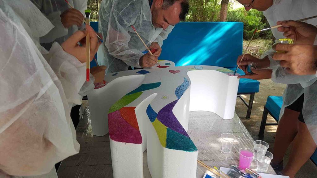 Team collaborating on a creative thinking challenge during a Catalyst team building activity think art