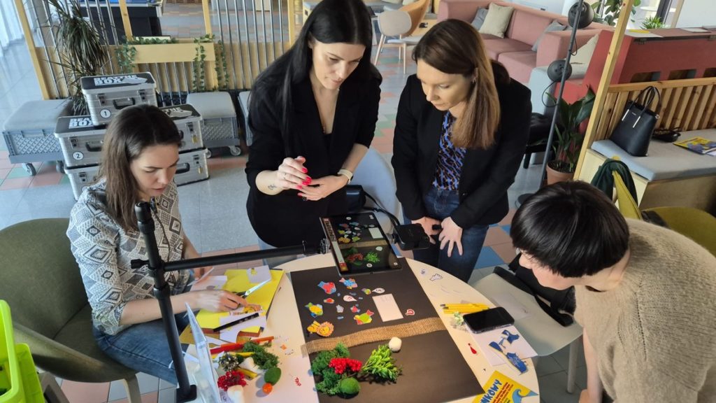 Team collaborating on a creative thinking challenge during a Catalyst team building activity animate