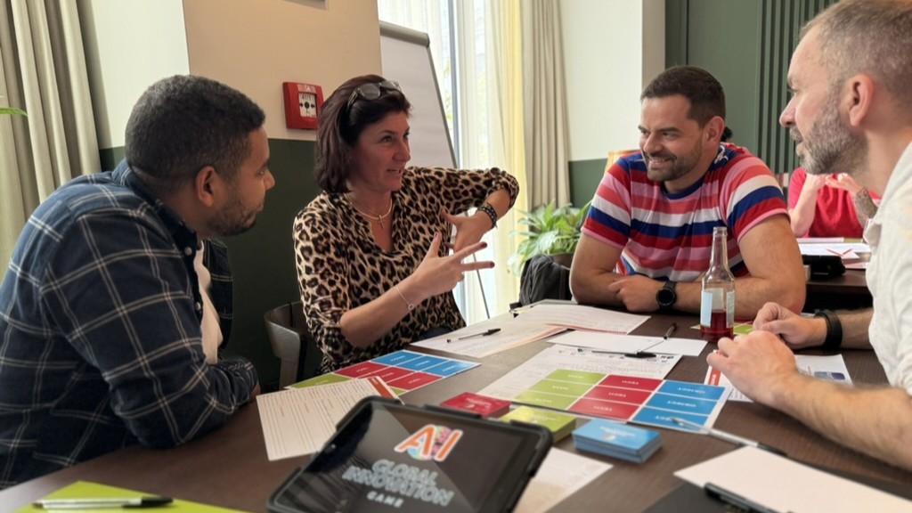 Team collaborating on a creative thinking challenge during a Catalyst team building activity global innovation game AI